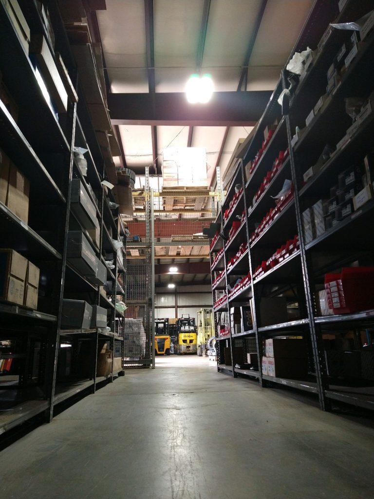 Aisle of shelves filled with an assortment of parts